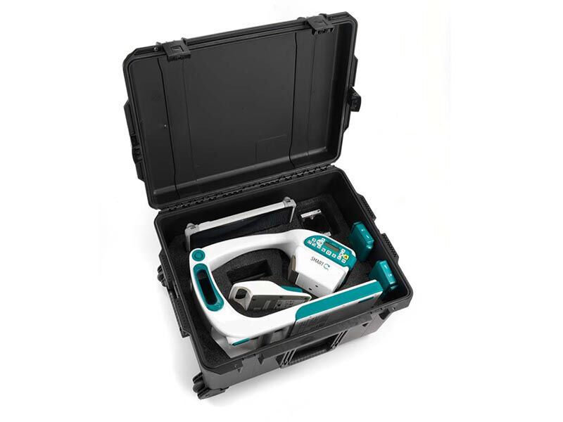 Portable X-ray machine, as a finished product, folded up in an open carrying case on a white background